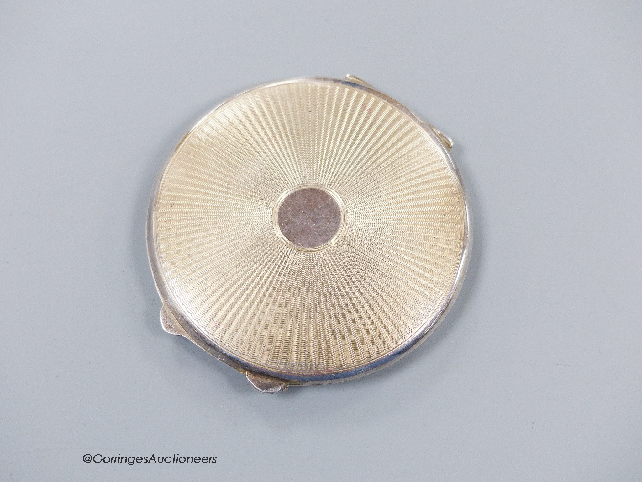 A George VI silver and yellow guilloche enamel circular compact, Birmingham, 1944, 65mm.